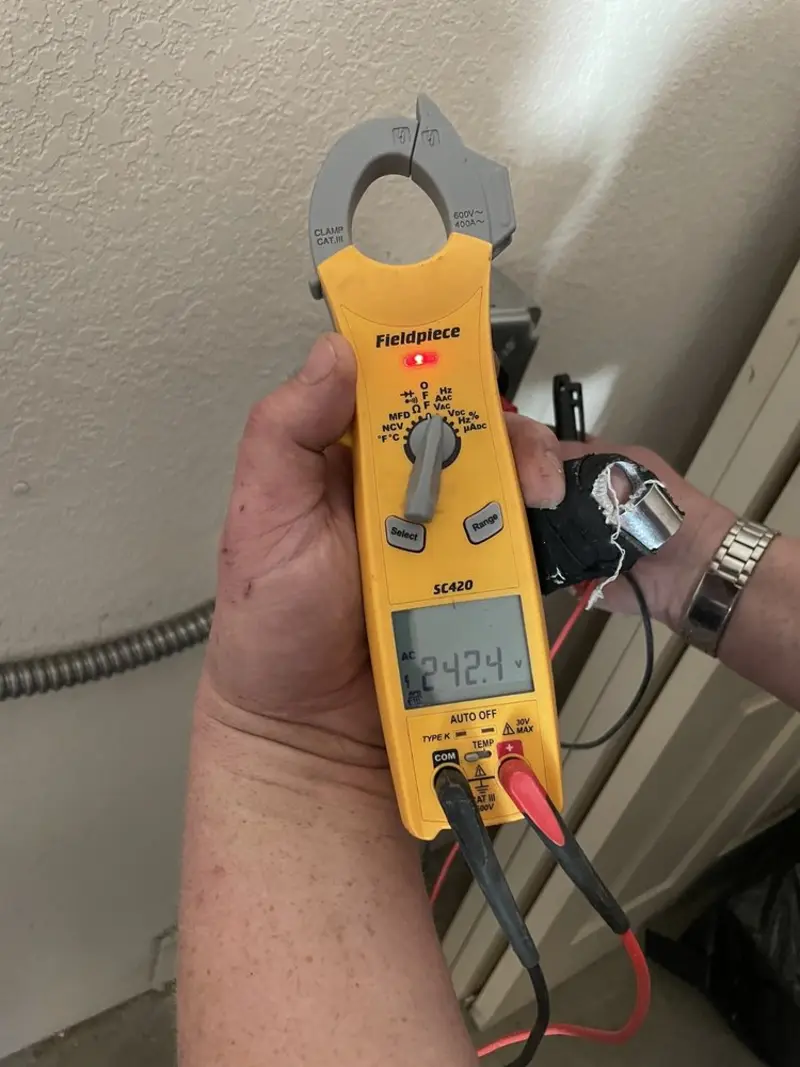 Voltage testing with clamp meter during Outlet Installation in West Frankfort